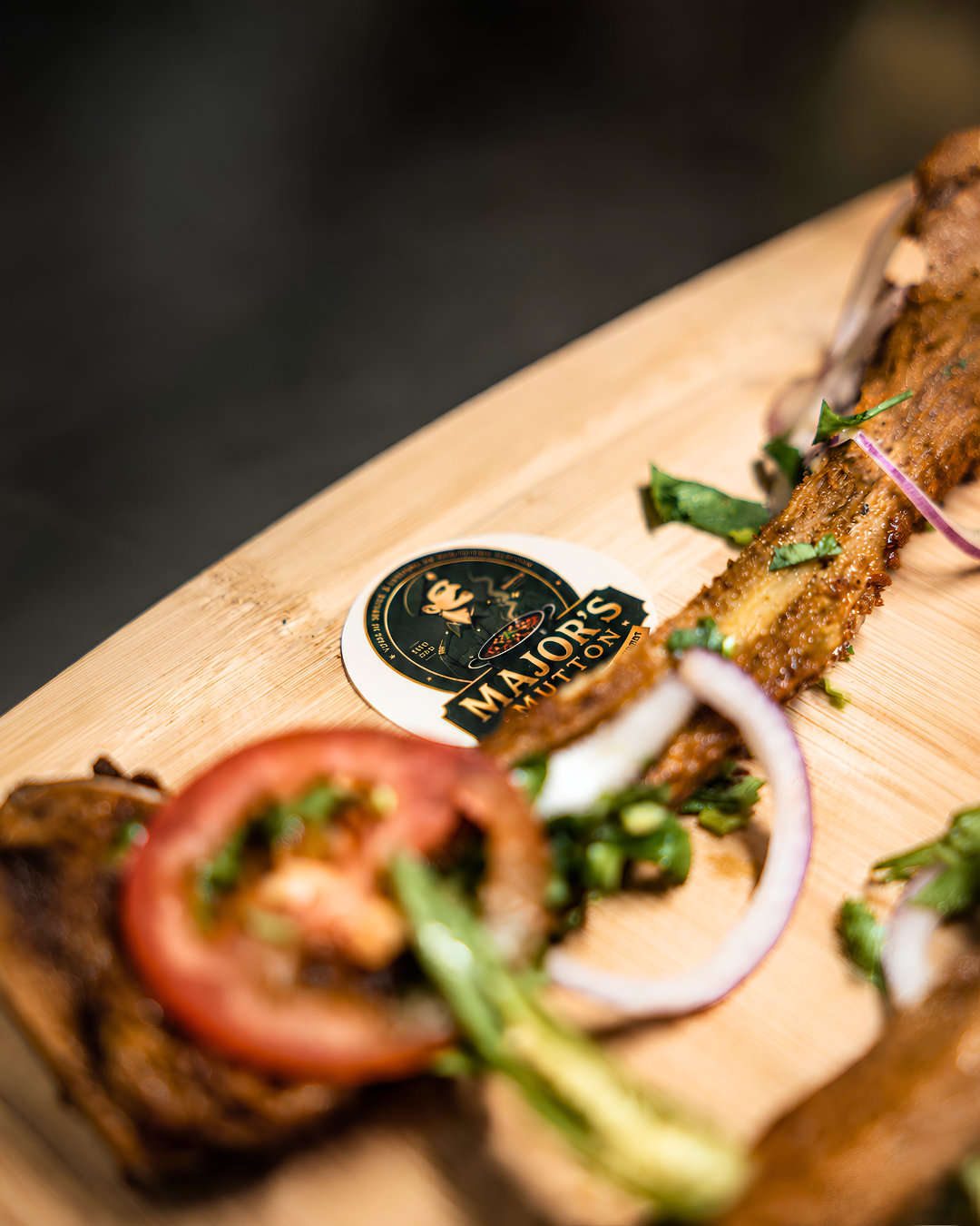 Grilled mutton platter on a wooden board with a Major's Mutton coaster